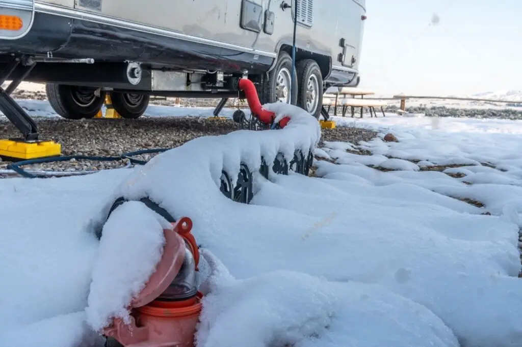 draining an RV tank using sewage hose on how to winterize a travel trailer 